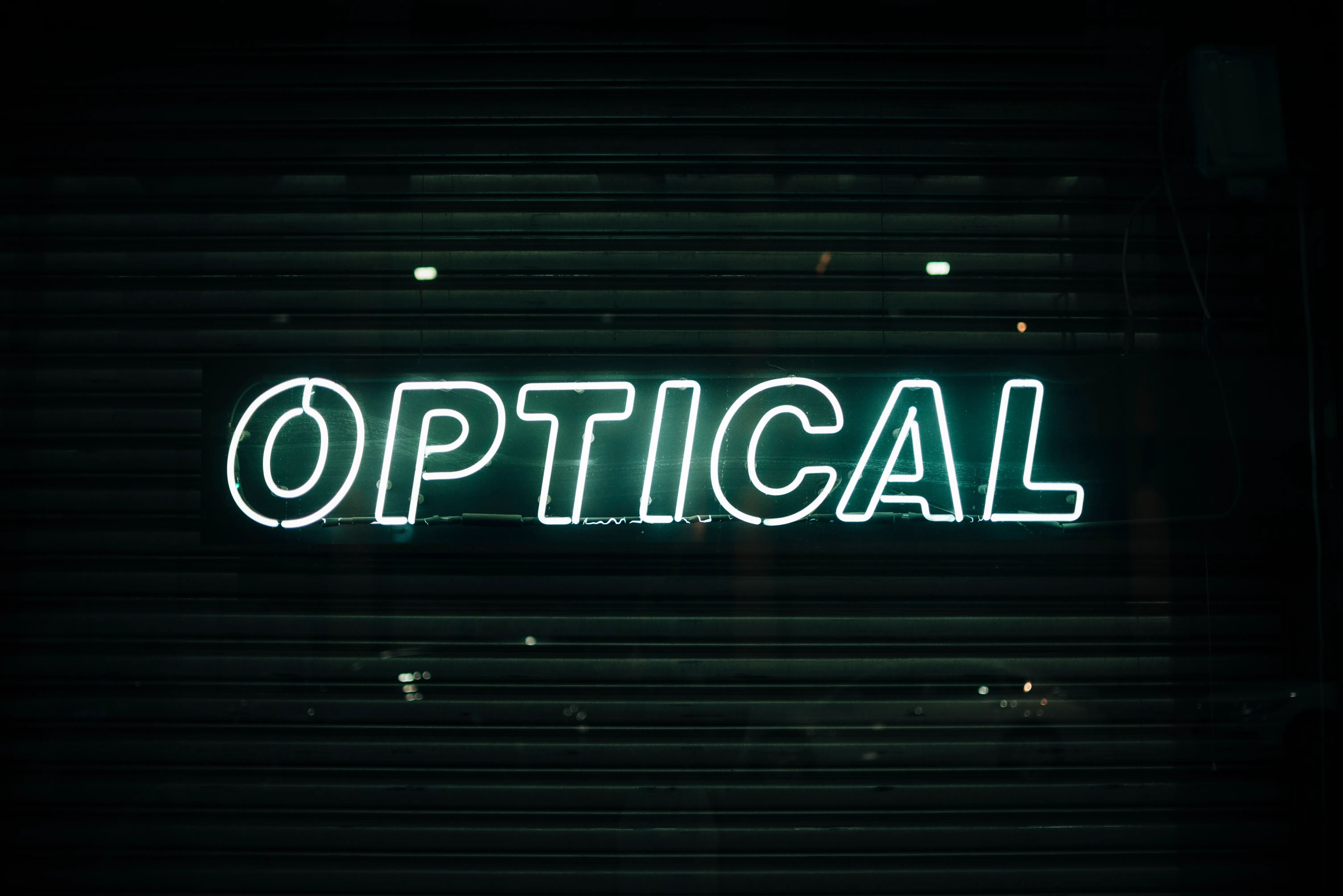 Optical store neon sign in pink and white tubing