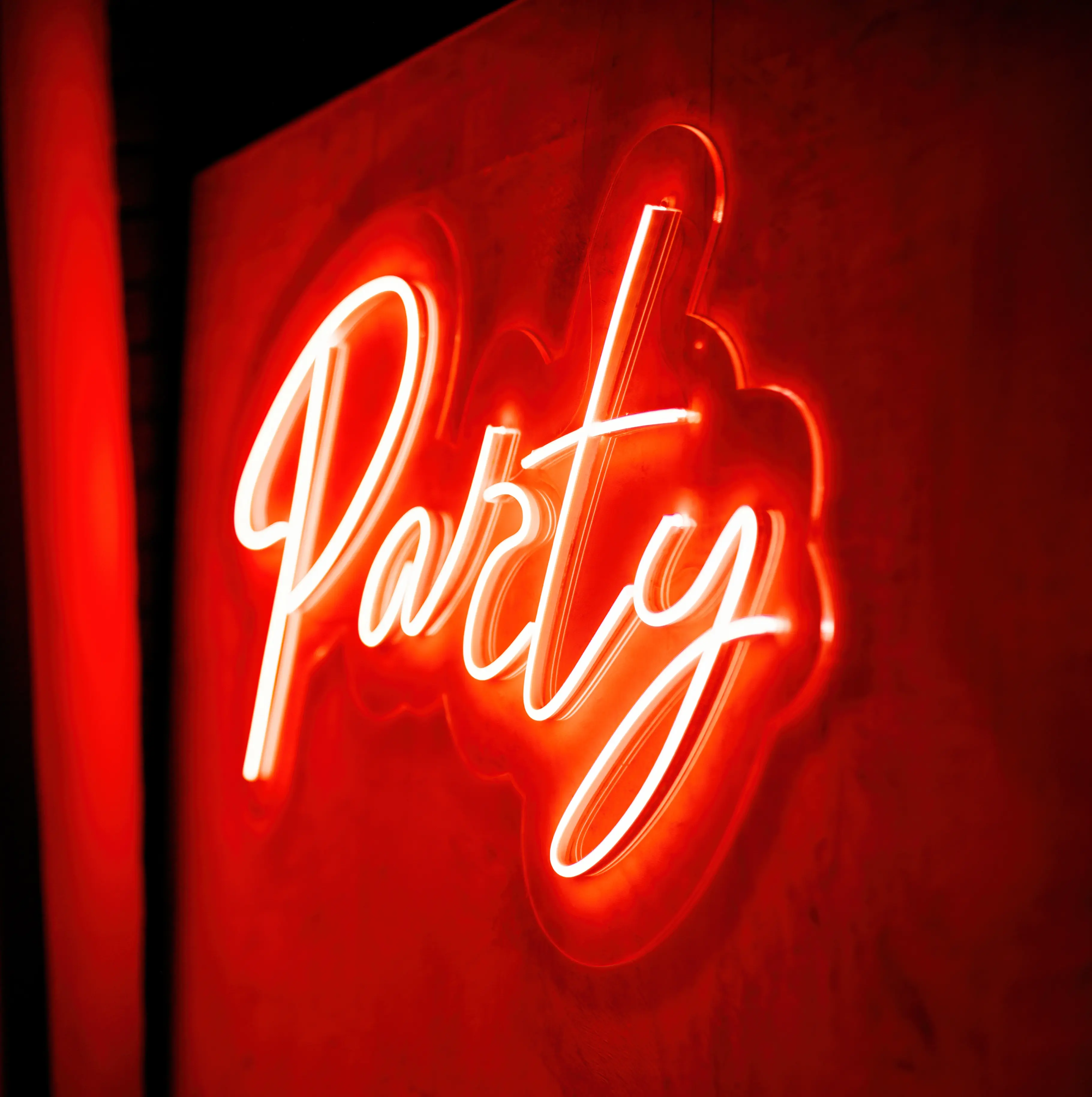 Party event LED neon sign mounted on a graphic wall