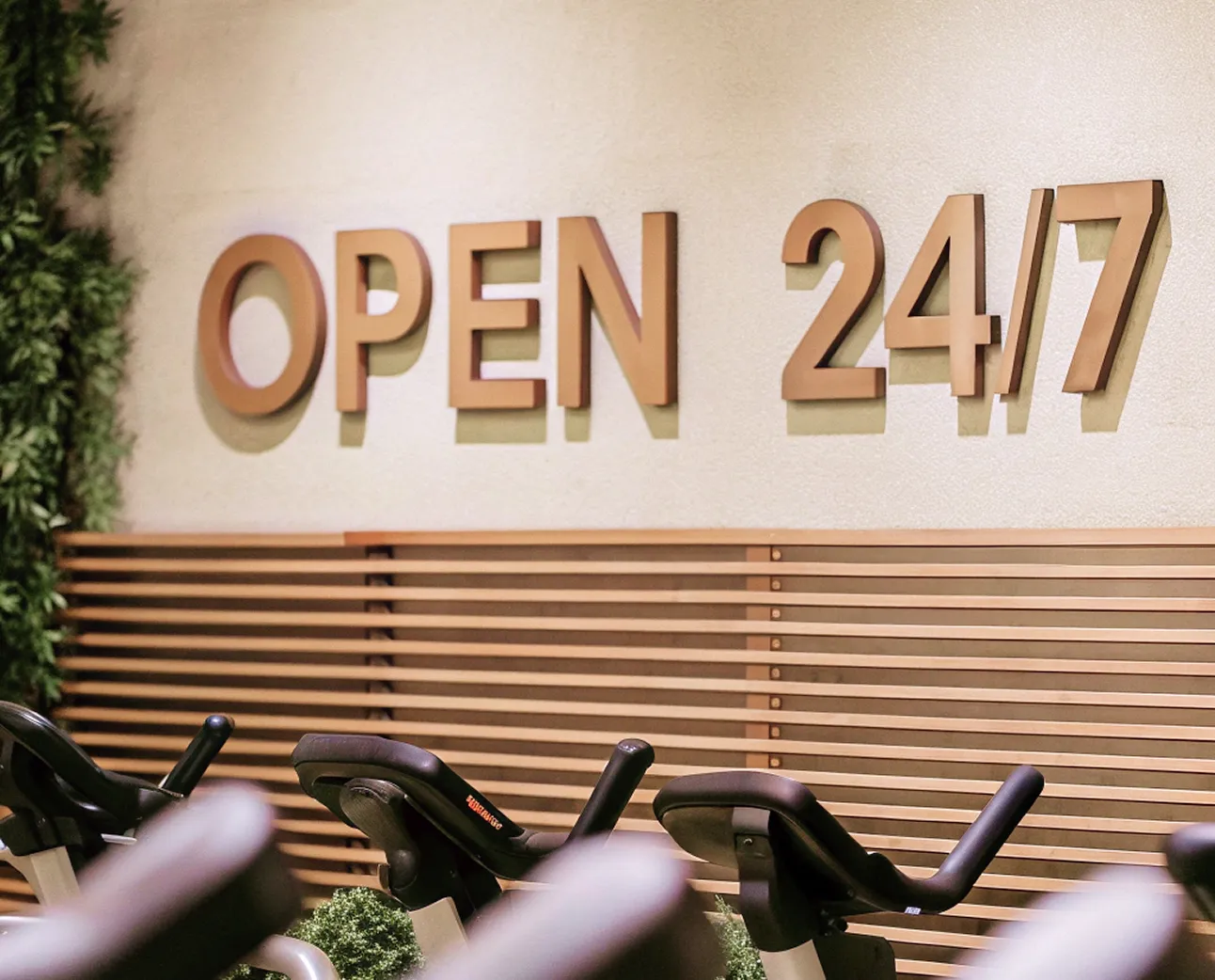 '24/7 Gym' wooden sign with backlit wood letters