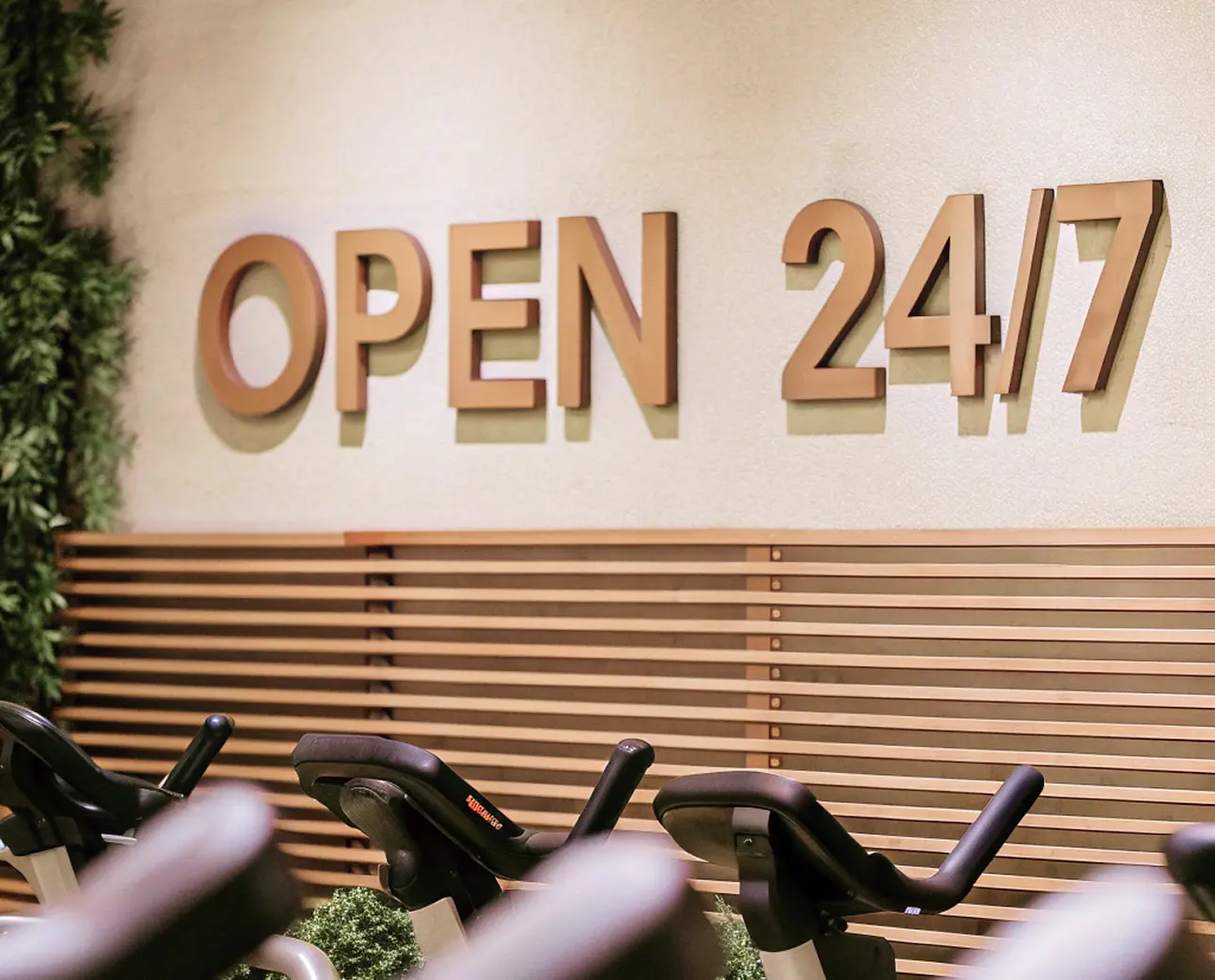 '24/7 Gym' wooden sign with backlit wood letters