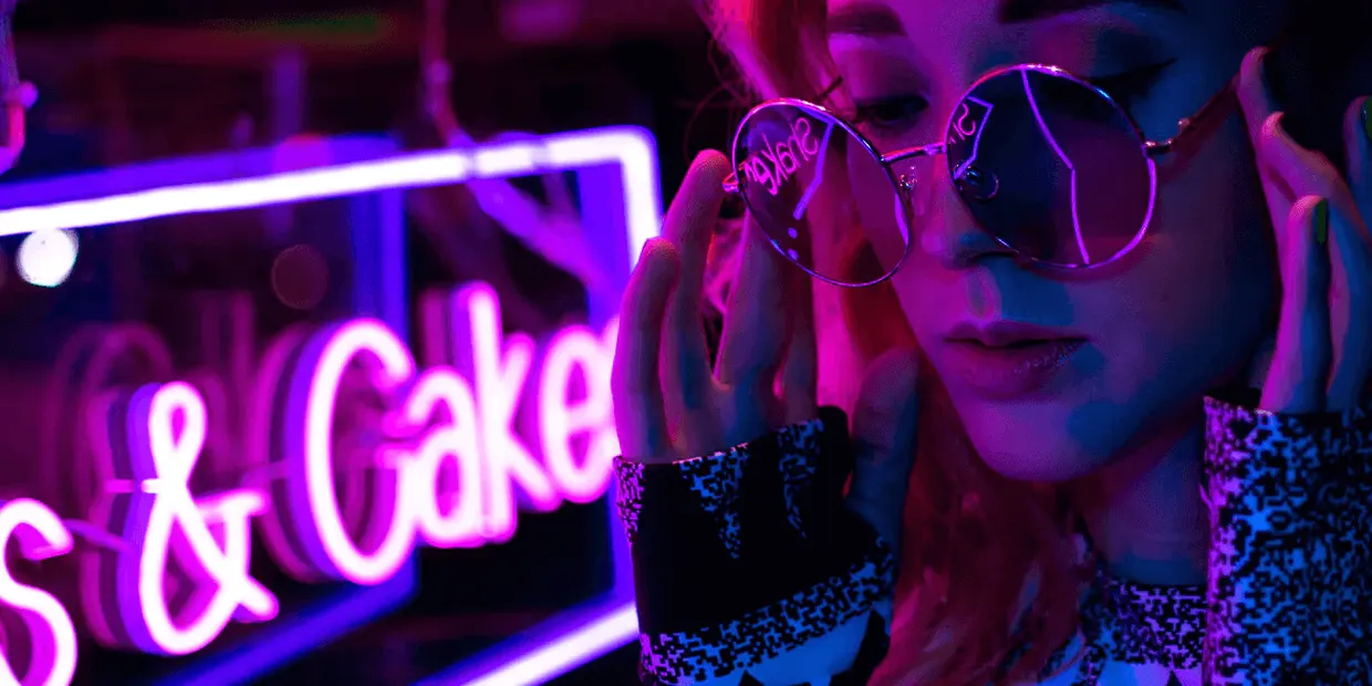 Glowing neon sign creating ambient lighting in a stylish bedroom